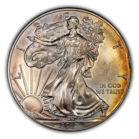 2012 Silver Eagle milk spot cluster error close-up on obverse under raking light